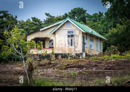 Abandoned old house with an ackee fruit tree in front, in Caribbean countryside Stock Photo