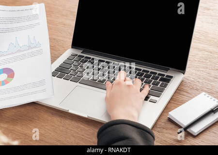 Partial view of woman typing on laptop keyboard Stock Photo