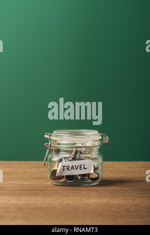 selective focus of glass jar with lettering filled coins on wooden background Stock Photo