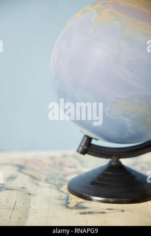 Selective focus of spinning globe and map isolated on blue Stock Photo