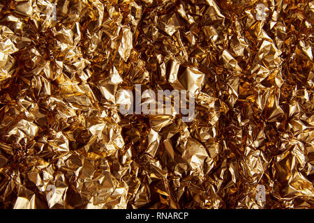 top view of crumpled golden foil with twinkles Stock Photo