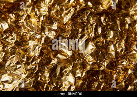 top view of crumpled golden foil with twinkles Stock Photo