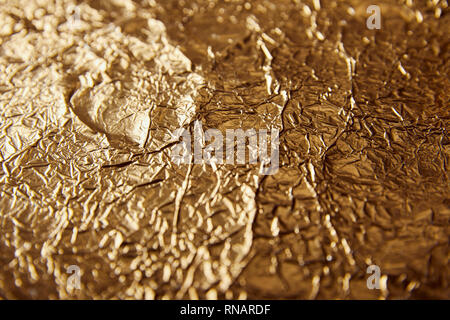sheet golden foil with blurred bright glares Stock Photo