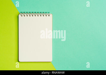 Top view of spiral notepad on colored surface. Flat lay style with place for text. Trendy color concept. Color of the year. Stock Photo