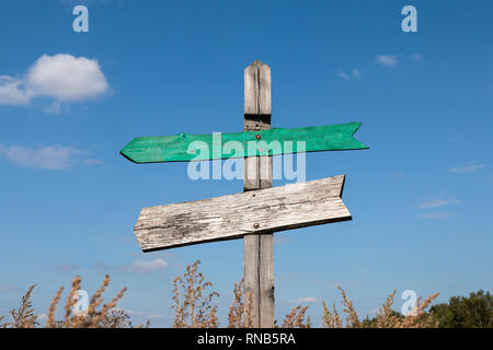 old wooden signpost with two arrows with copy space Stock Photo