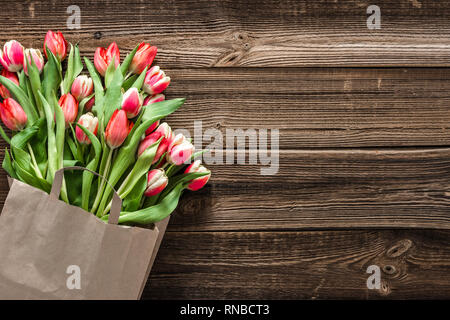 Colorful spring flowers, bouquet of tulips on wooden background useful as mother's day card or women's day gift Stock Photo