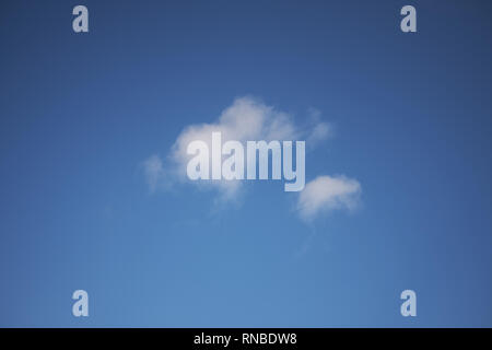 An isolated white cloud in a blue sky Stock Photo
