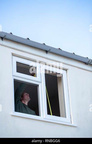 Construction Worker Installing New Windows In House Stock Photo
