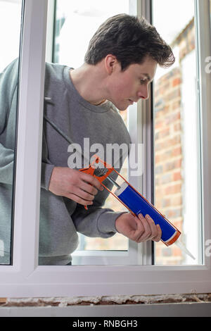Construction Worker Installing New Windows In House Stock Photo