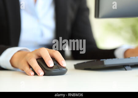 Close up of an office worker hand using computer mouse on a desk Stock Photo