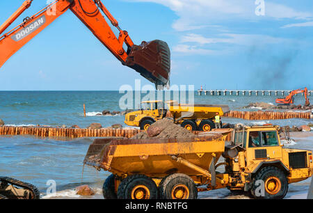 construction of breakwaters, construction equipment on the sea coast, Baltic sea, Kaliningrad region, Russia, July 15, 2018 Stock Photo