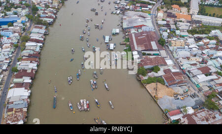 Tourists, people buy and sell food, vegetable, fruits on vessel, boat, ship in Cai Rang floating market, Mekong River. Royalty stock image of traffic Stock Photo