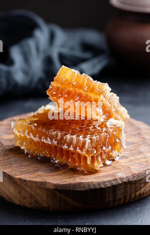 Honeycombs on wooden board. Raw honey, natural organic honey. Selective focus, rustic style Stock Photo