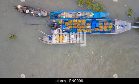 Tourists, people buy and sell food, vegetable, fruits on vessel, boat, ship in Cai Rang floating market, Mekong River. Royalty stock image of traffic Stock Photo