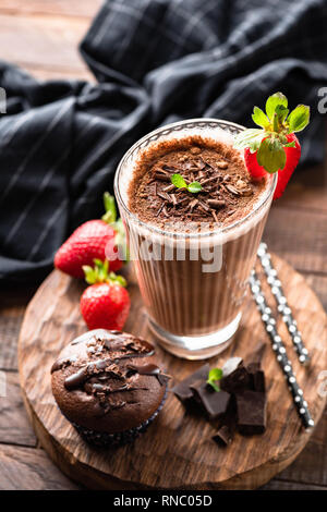 Tasty Chocolate Cocktail, Ice Mocha Coffee Cappucino or Milkshake In Tall Glass Cup Served With Chocolate Muffin. Selective focus Stock Photo