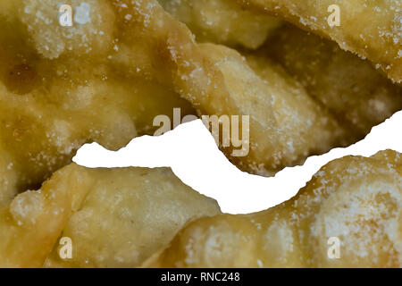 Macrophoto.European dessert angel wings. Interesting texture of deep fried dough strips with with a hole in the middle. Site about  pastries, sweets. Stock Photo