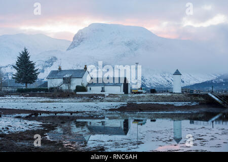 Corpach lighthouse reflections with Ben Nevis from Corpach, Fort William, Scotland on a cold winters day in February Stock Photo