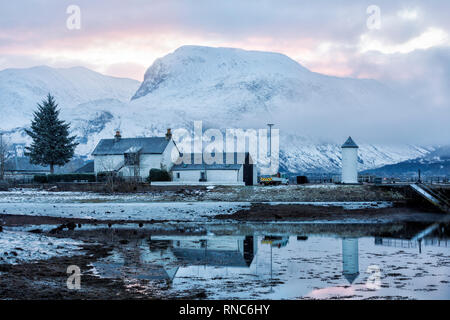 Corpach lighthouse reflections with Ben Nevis from Corpach, Fort William, Scotland on a cold winters day in February - hdr effect Stock Photo