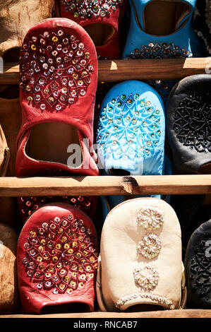 Colourful leather slippers known as babouches, in the market place of a souk in Marrakech, Morocco Stock Photo