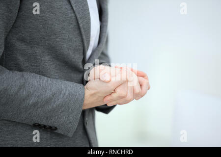 close up.thoughtful businessman folded his hands in front of him Stock Photo