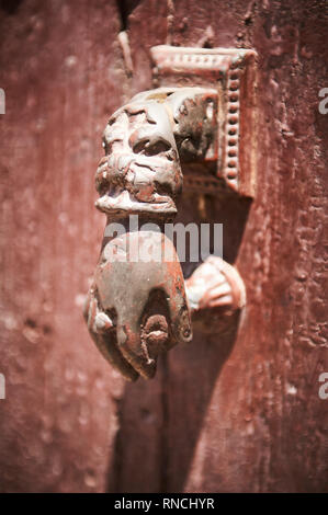 Ornate intricate hand of fatima brass door knocker intended to keep you protected from the evil eye in Marrakech. Stock Photo