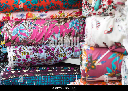 Fabrics stacked in a textile store. Various multicolored prints. Saara, Rio de Janeiro, Brazil. 2019 Stock Photo