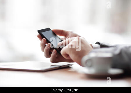 close up.the businessman uses a smartphone. photo with copy space Stock Photo