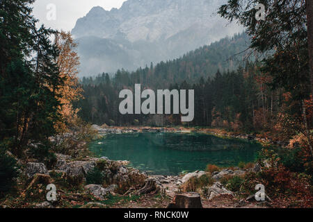 beautiful lake with mountains on background in Bavarian Alps in the morning with a fog, Germany, Europe Stock Photo
