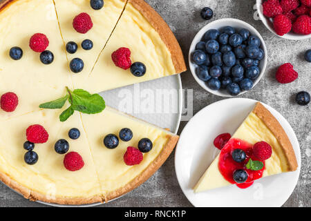 Classic sliced cheesecake with jam on stone background, top view. yummy breakfast Stock Photo