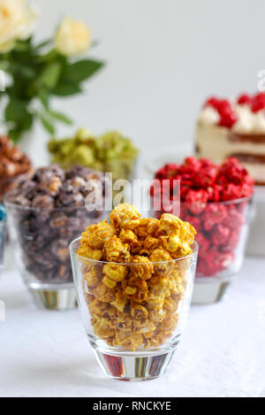 Party table with colorful popcorn in glasses
