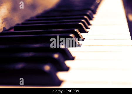 Close up piano keys black and white in light red sepia Stock Photo