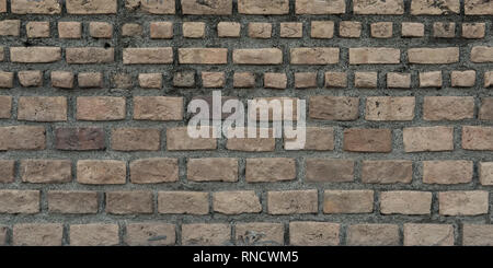 Old bricks and cement, wall texture, stone surface closeup. Grunge building material, wallpapers or background Stock Photo