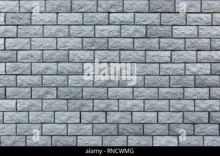 Gray stone bricks, wall texture, rocky surface closeup. Decorative building material, wallpapers or background Stock Photo