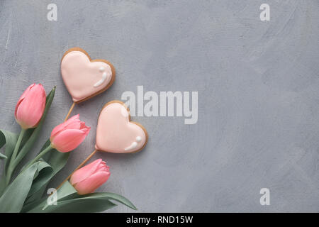 Springtime background with pink tulips on grey concrete background, copy-space Stock Photo