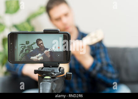 Handsome man recording song. Vlogging concept. Stock Photo
