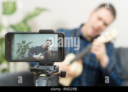 Handsome man recording song. Vlogging concept. Stock Photo