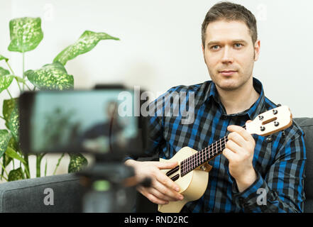 Handsome man recording song. Vlogging concept. Stock Photo