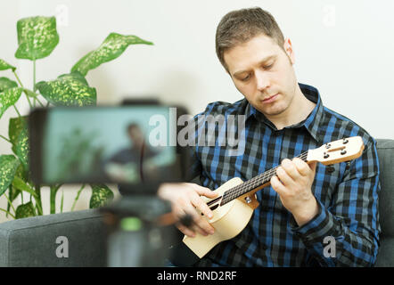 Handsome man recording song. Vlogging concept. Stock Photo