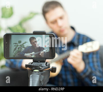 Handsome man recording song. Vlogging concept. Stock Photo