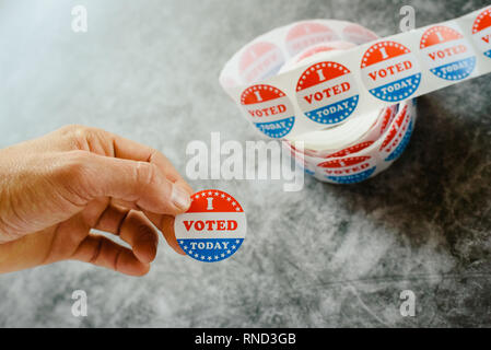 Man hand holding supporter stickers of american elections Stock Photo
