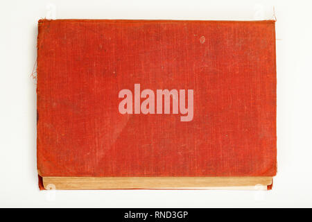 Red old book with battered cover on white background. Stock Photo