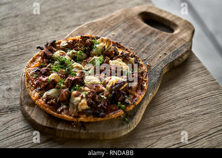 Cooked Jackfruit vegetarian pizza on wooden board Stock Photo