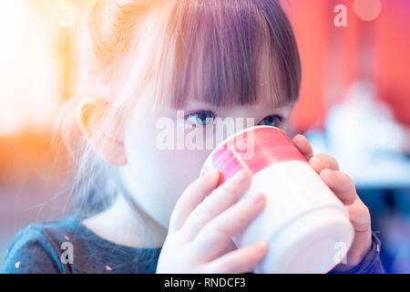 Little girl holding a mug Stock Photo