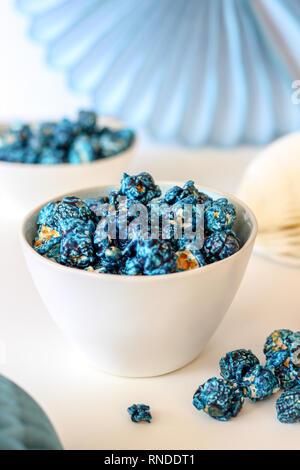 Blueberry popcorn on bowls and blue paper decorations Stock Photo