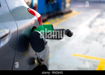 Nozzle in the car for adding petrol close up Stock Photo