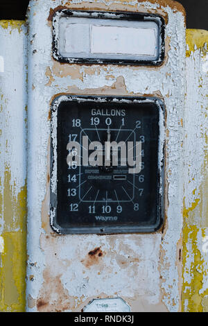 Close up of a rusty old single yellow petrol pump, with a large dial showing gallons Stock Photo