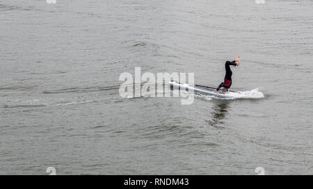 Surfer doing a hand stand in the sea at Saltburn-by-the-sea, North Yorkshire, England Stock Photo