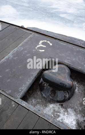 Wet black mooring bollard mounted in Neva river coast Stock Photo