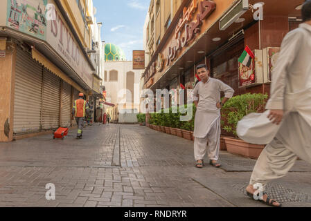 Pakistani men walking and staring at the camera in a street of the popular and ethnic Deira district in Dubai, United Arab, Emirates, Stock Photo