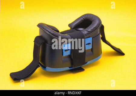 Modern blue glasses of virtual reality for smartphone and phone on yellow background, close-up, technology Stock Photo